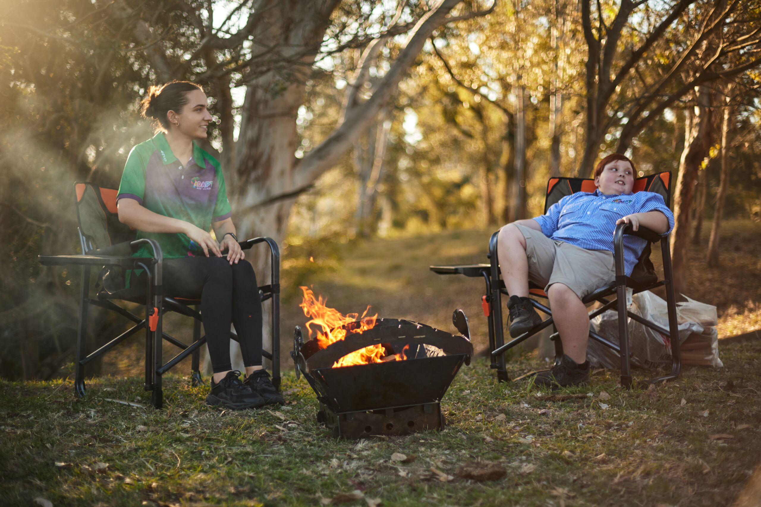 therapist with a student sitting on camping chairs