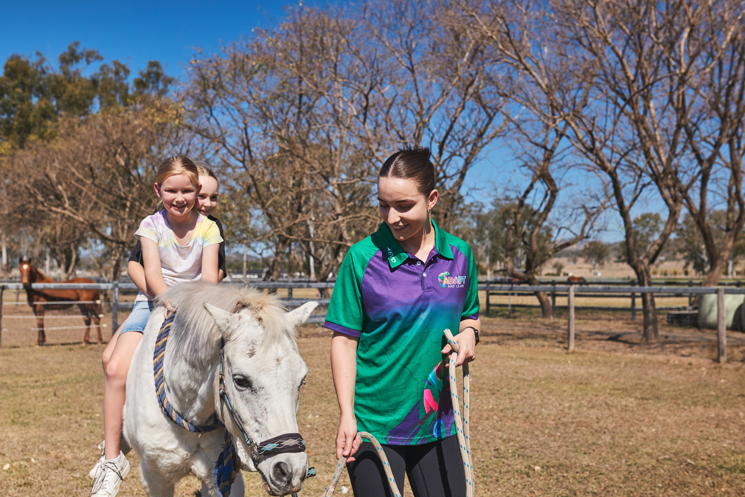 Therapist with students riding a horse