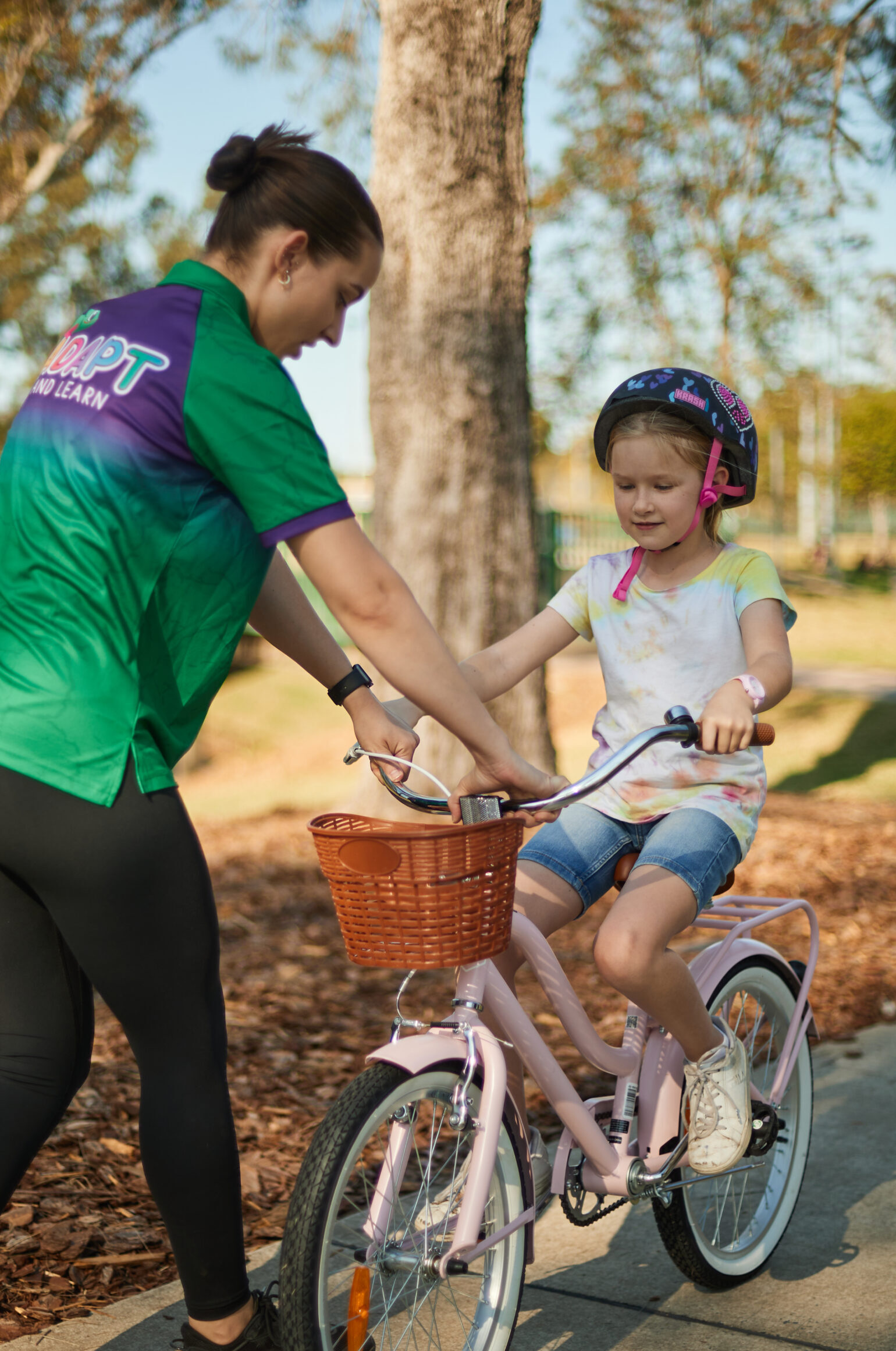 Therapist with a student riding a bike