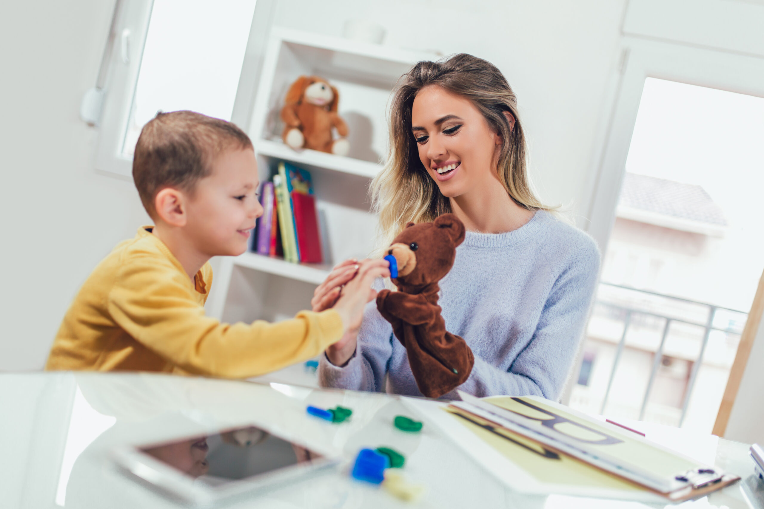 Toddler boy in child occupational therapy session doing sensory