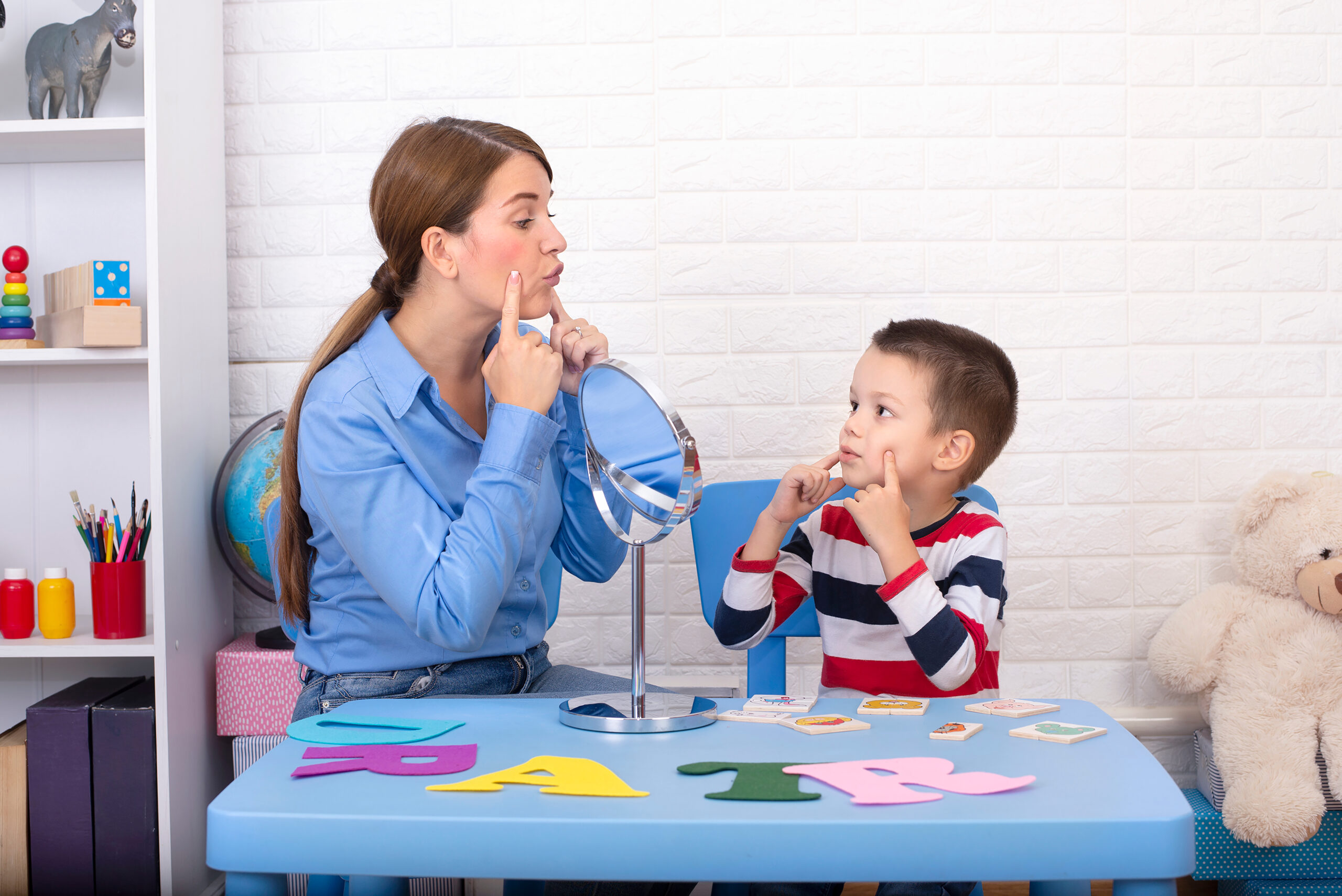 Toddler boy in child occupational therapy session doing sensory