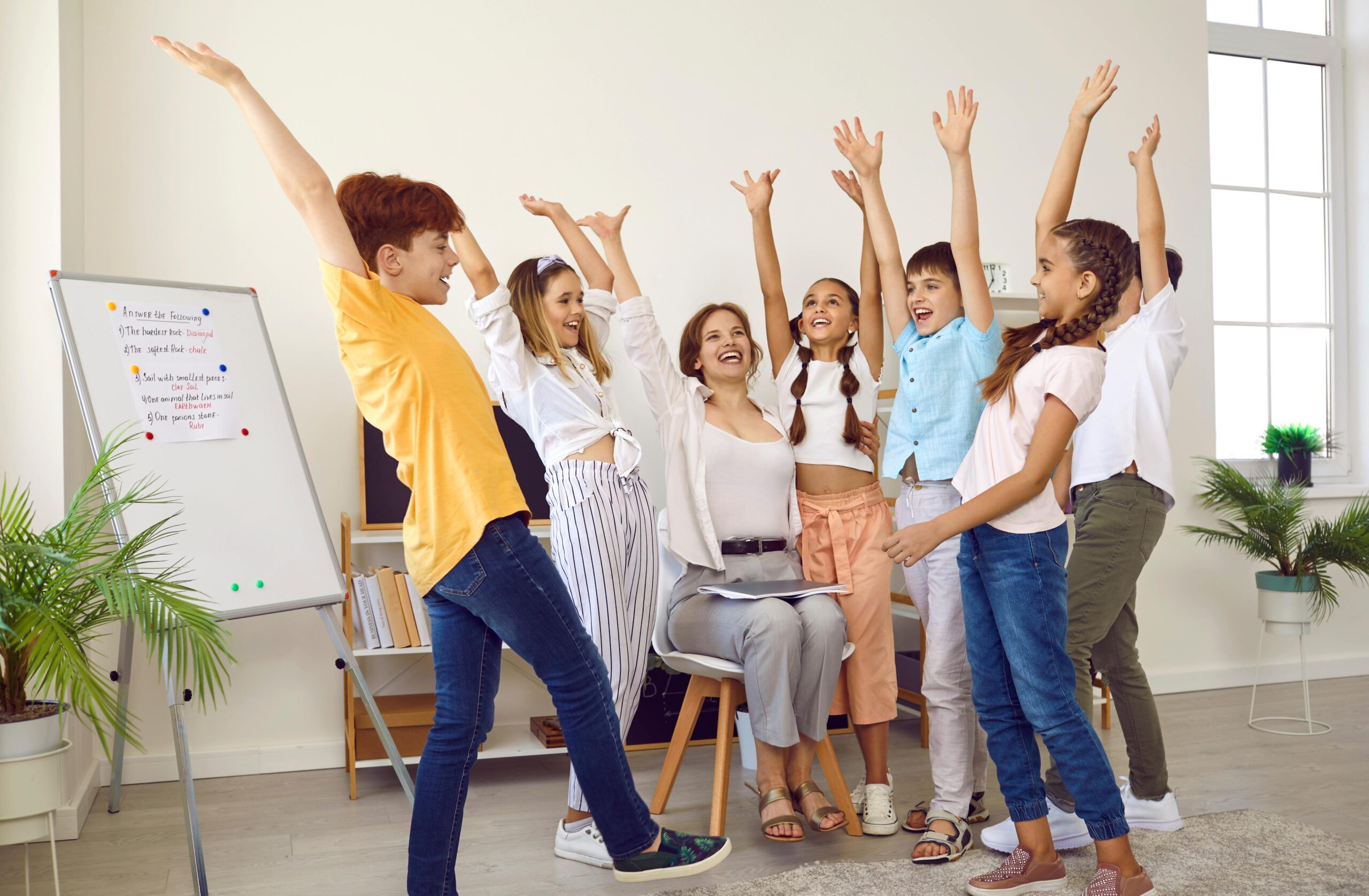 children on a tutoring program raising their hands