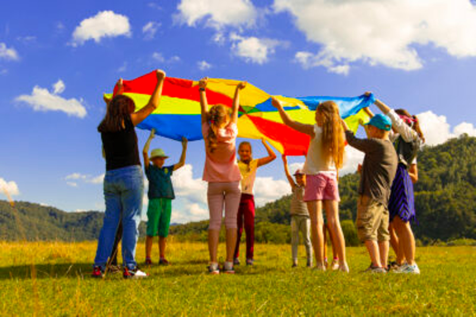 children holding a colorful umbrella