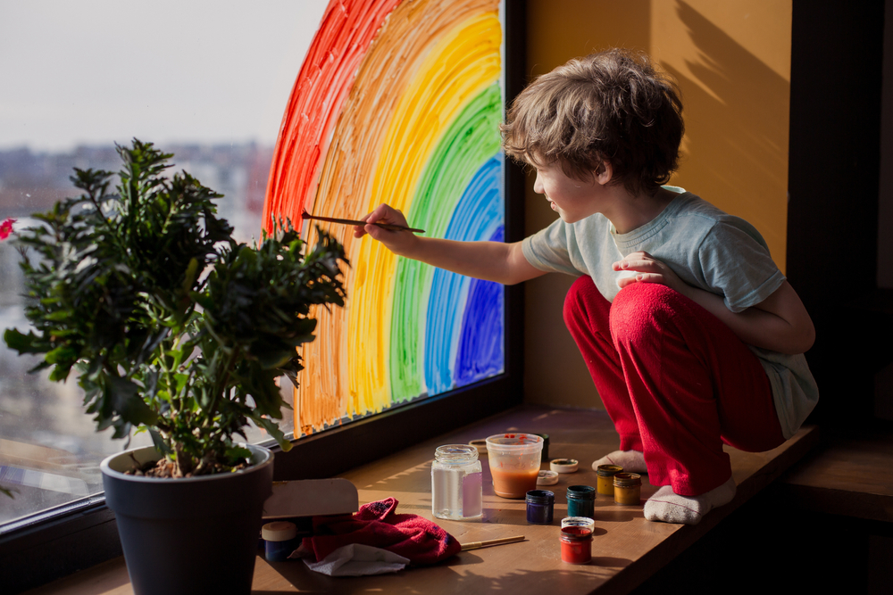 child draws a rainbow